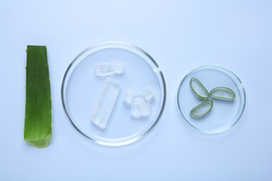 Photo of Flat lay composition with cut aloe vera on light blue background