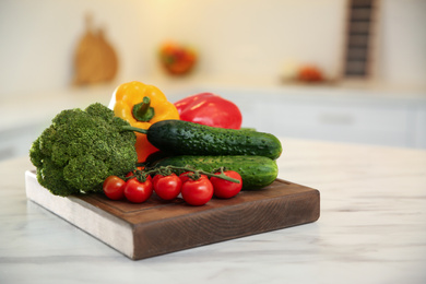 Photo of Fresh vegetables on table in kitchen, closeup. Cooking at home