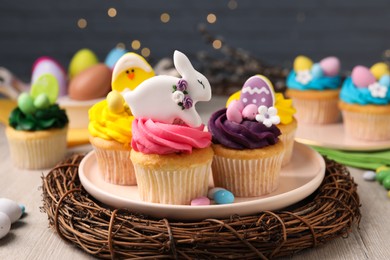 Photo of Tasty decorated Easter cupcakes on wooden table