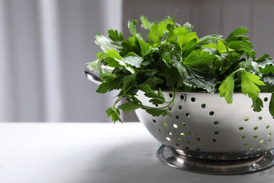 Photo of Fresh green parsley on table, closeup. Space for text