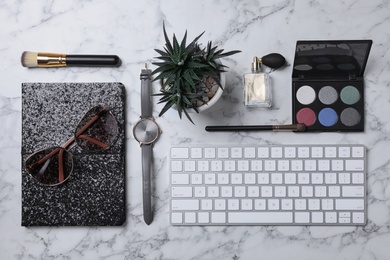 Flat lay composition with keyboard and blogger's stuff on marble background