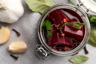 Delicious pickled beets and spices on table, flat lay