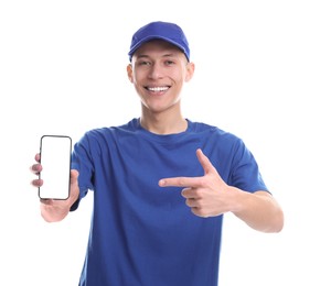 Happy courier pointing at smartphone on white background