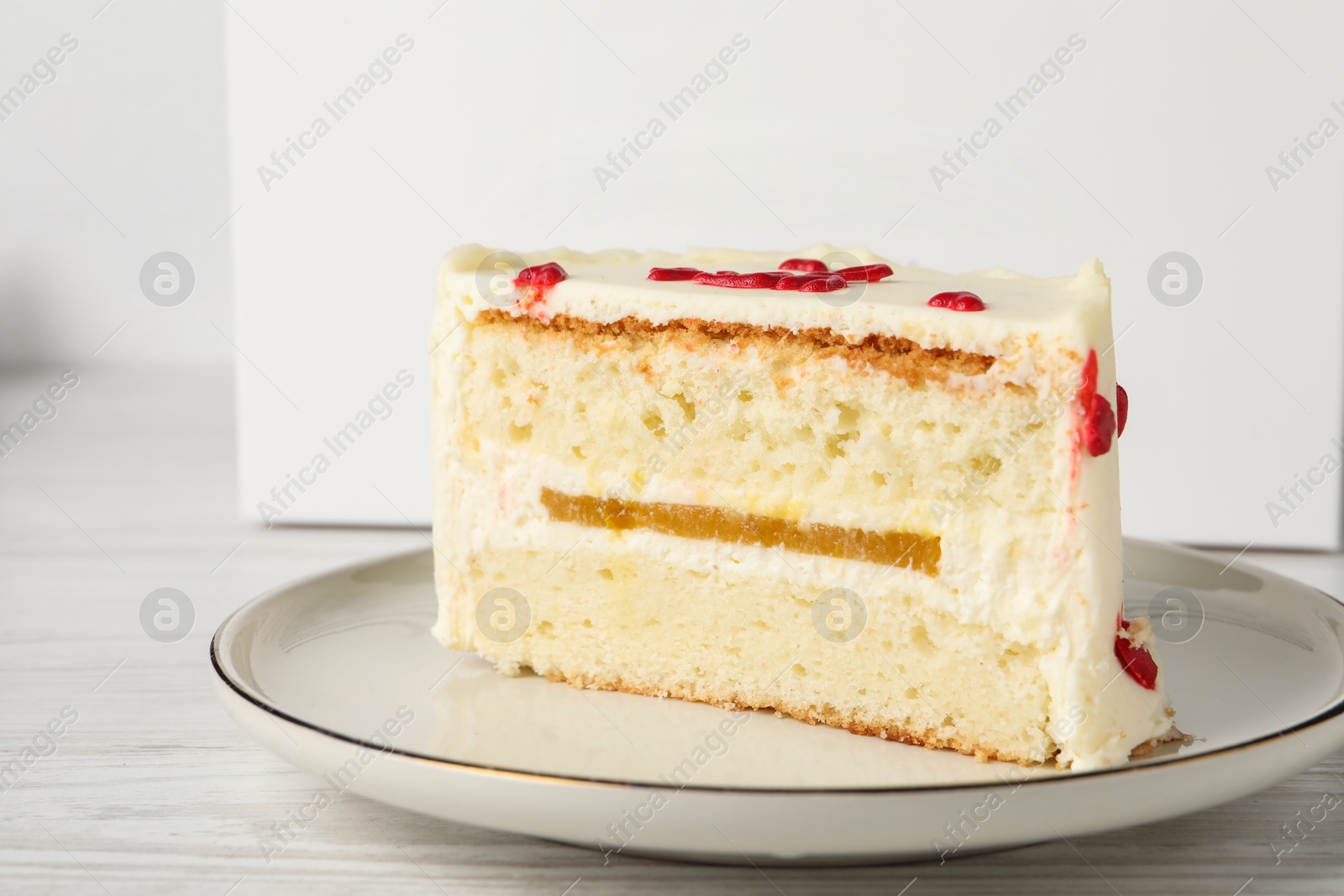 Photo of Cut bento cake on white table, closeup