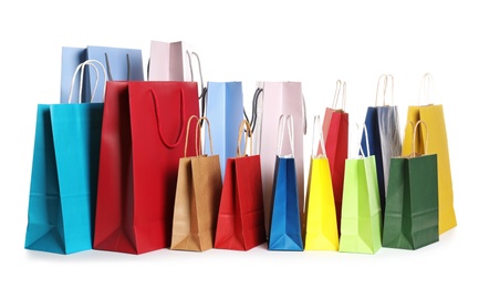 Colorful paper shopping bags on white background