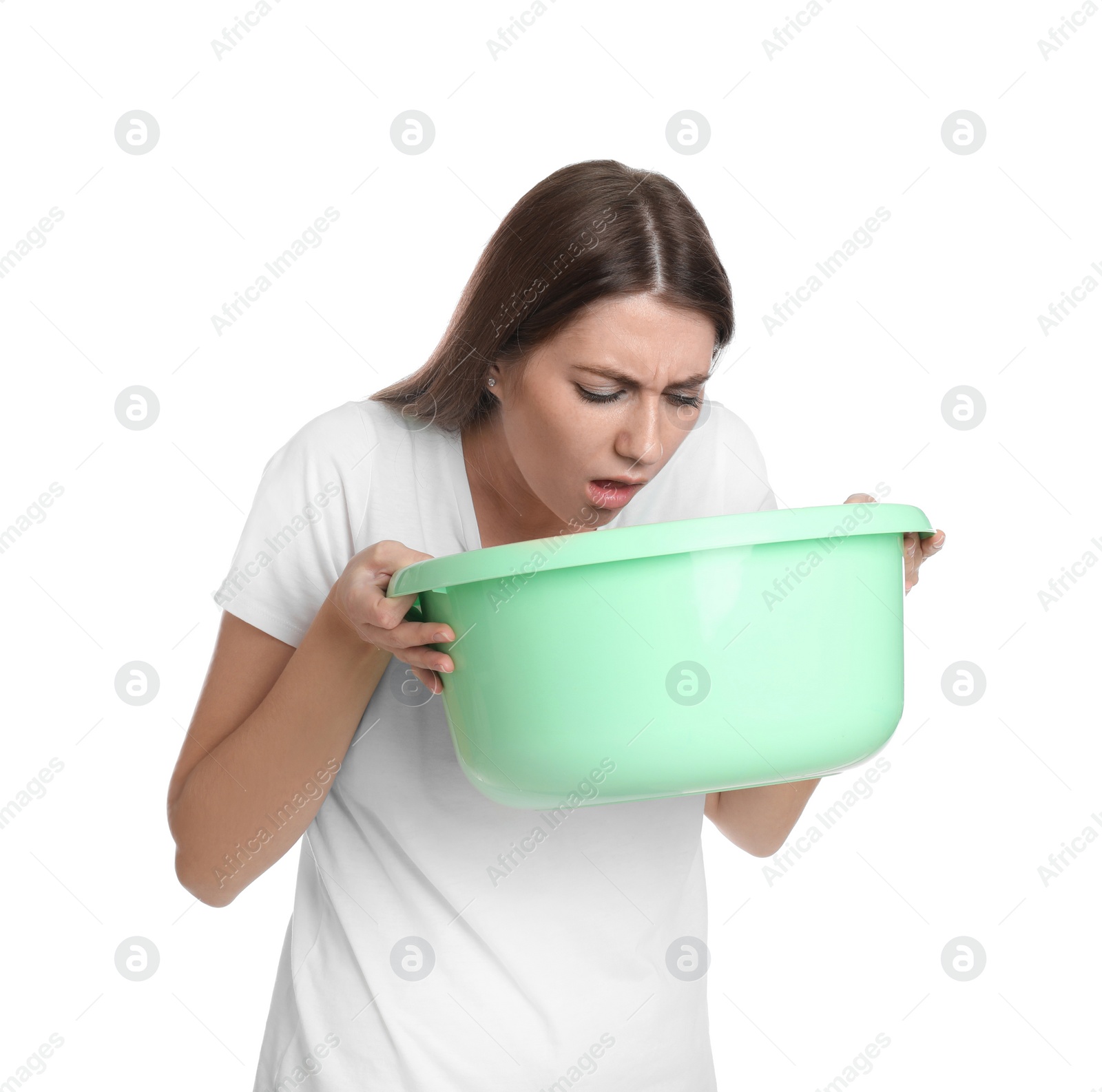 Photo of Woman with basin suffering from nausea on white background. Food poisoning