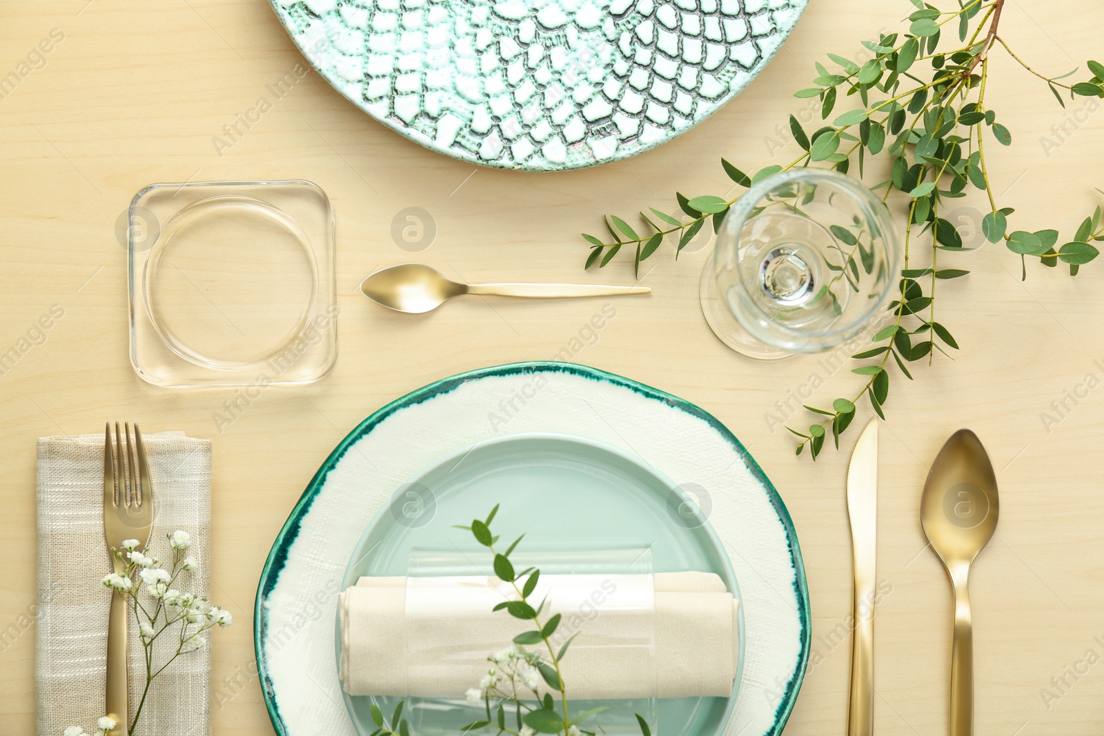 Photo of Elegant table setting with flowers and leaves, flat lay