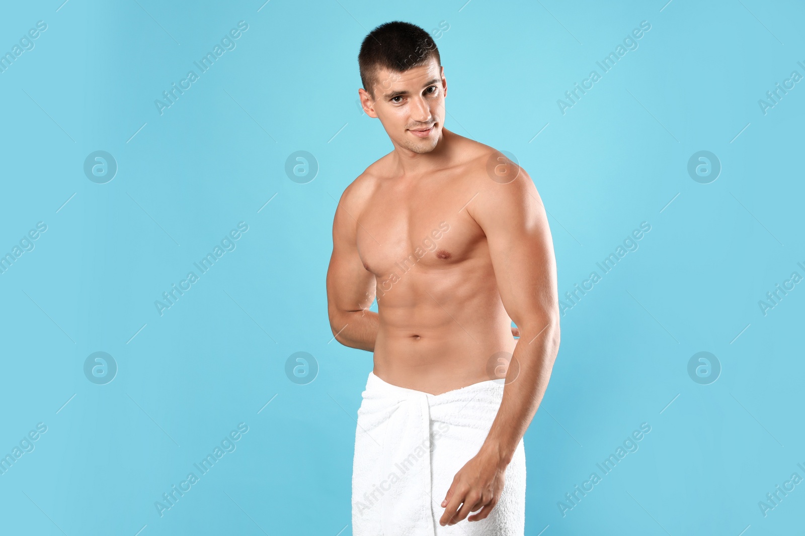 Photo of Young man with slim body on light blue background