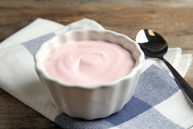 Photo of Bowl with creamy yogurt served on table