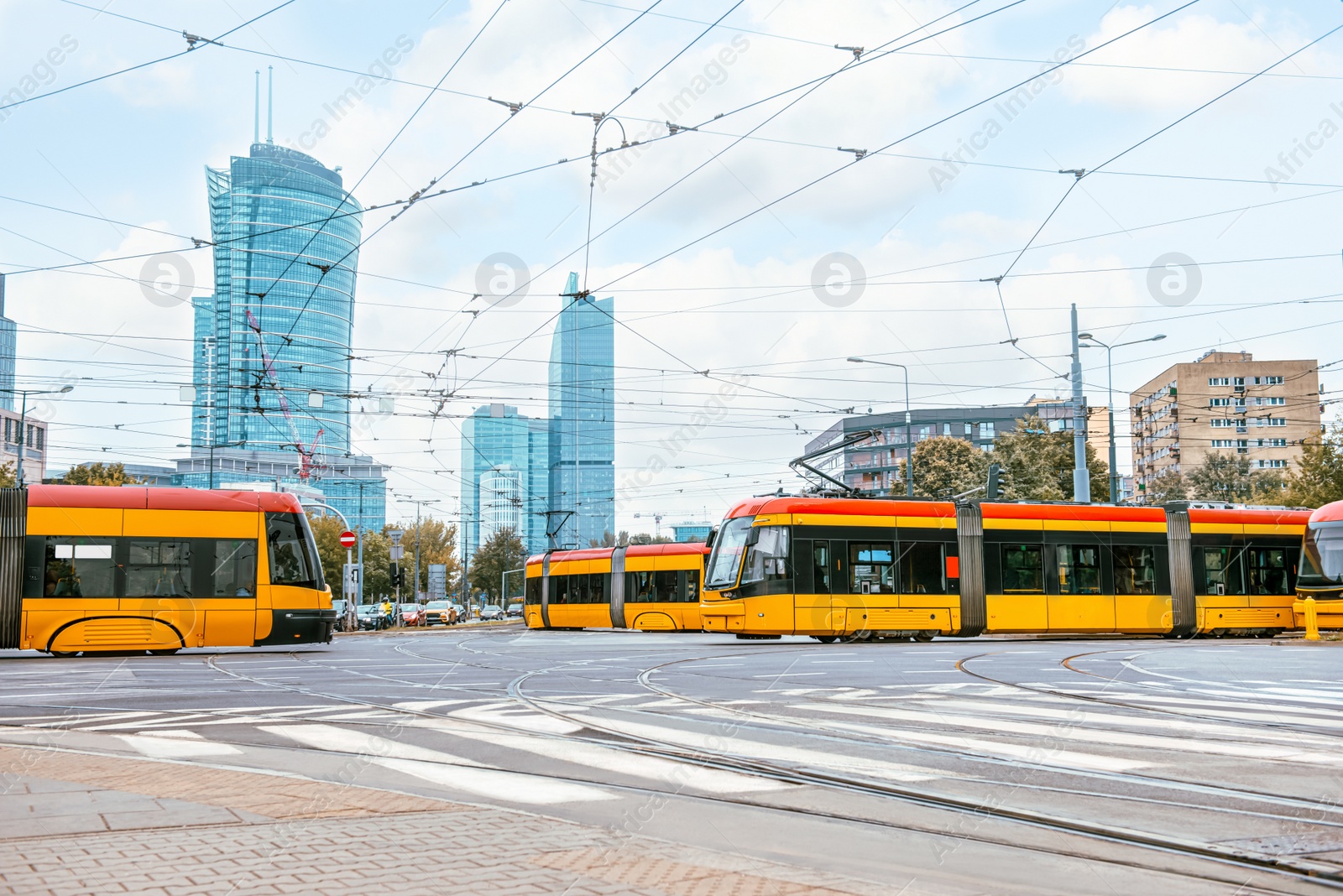 Photo of Modern trams on city street. Public transport