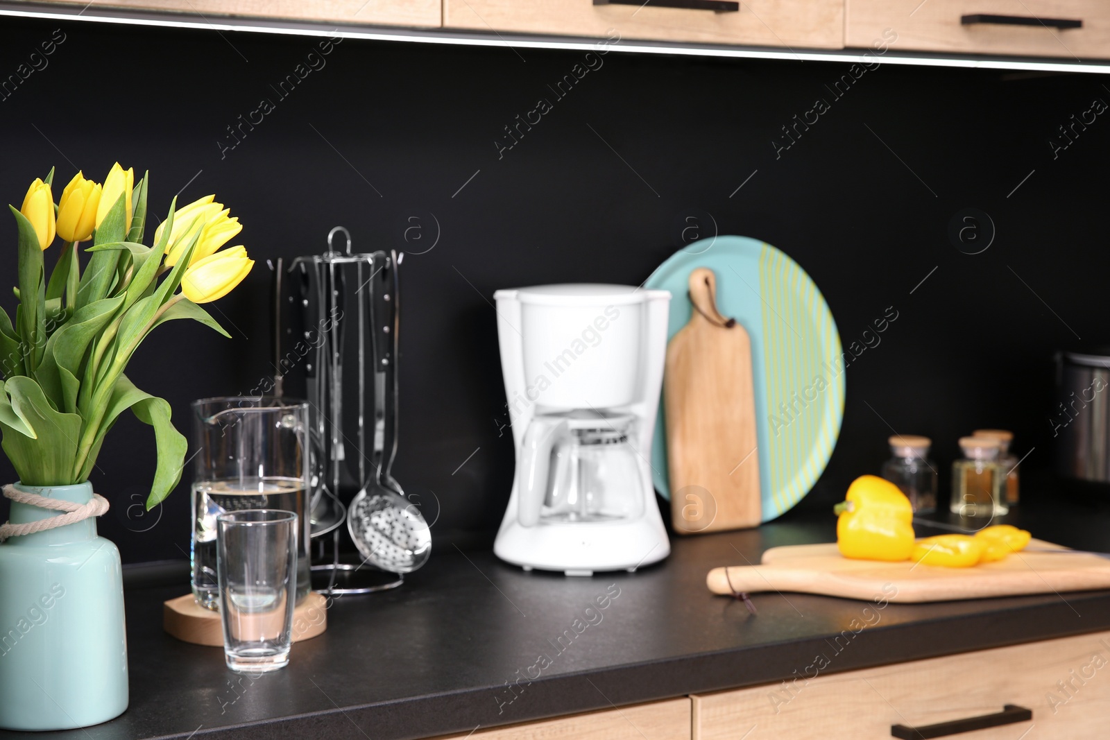 Photo of Stylish kitchen counter with set of houseware