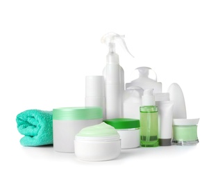 Different body care products and towel on white background