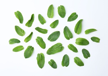 Flat lay composition with fresh green mint leaves on white background