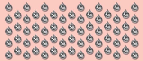Many shiny disco balls on pink background, flat lay. Banner design