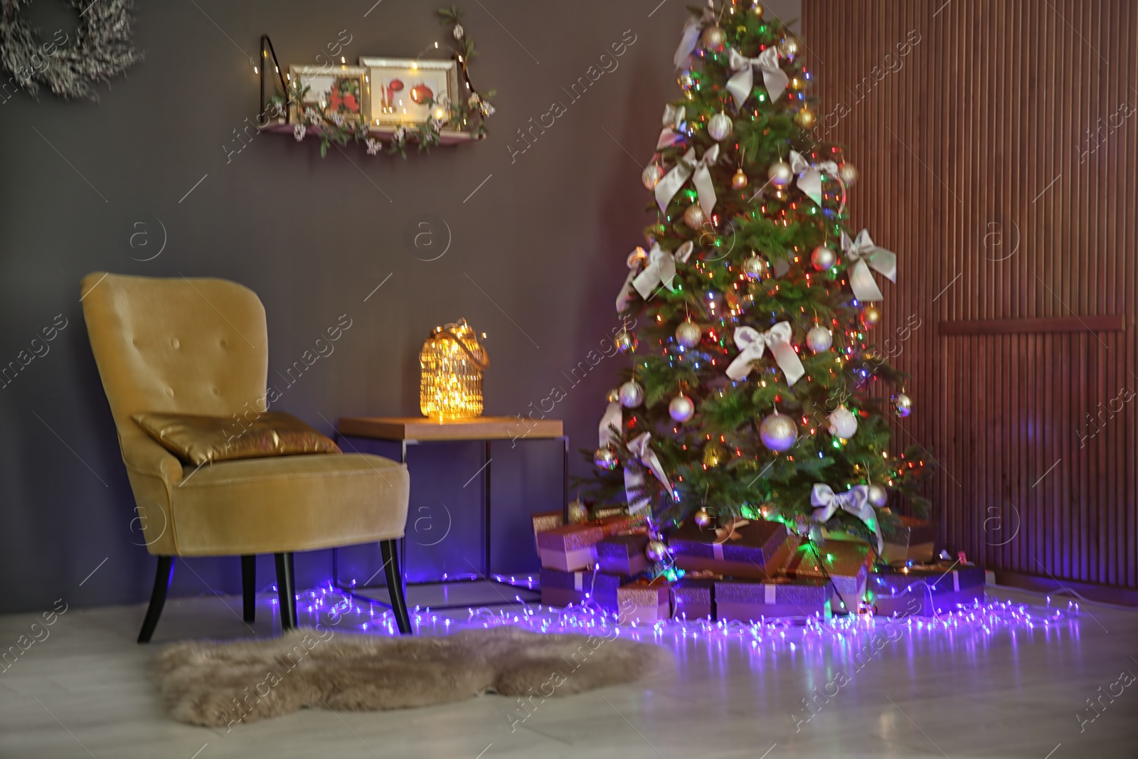 Photo of Room interior with beautiful Christmas tree and gifts