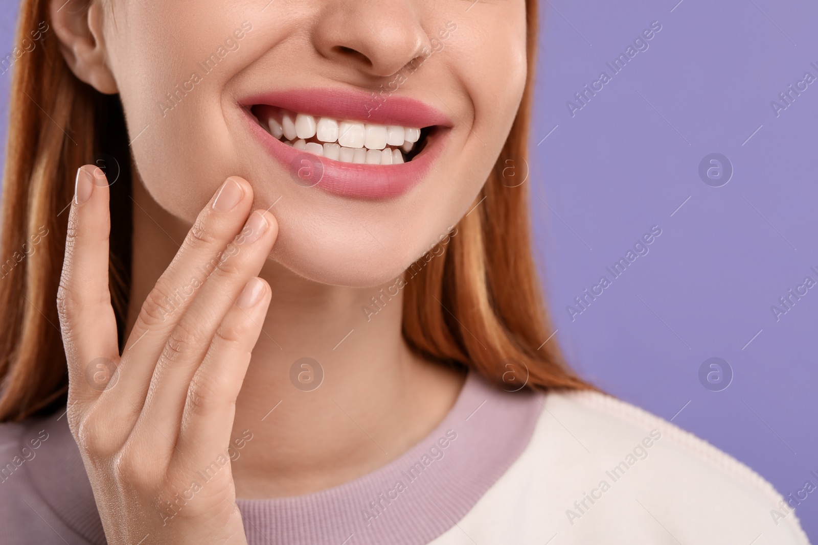 Photo of Woman with clean teeth smiling on violet background, closeup. Space for text