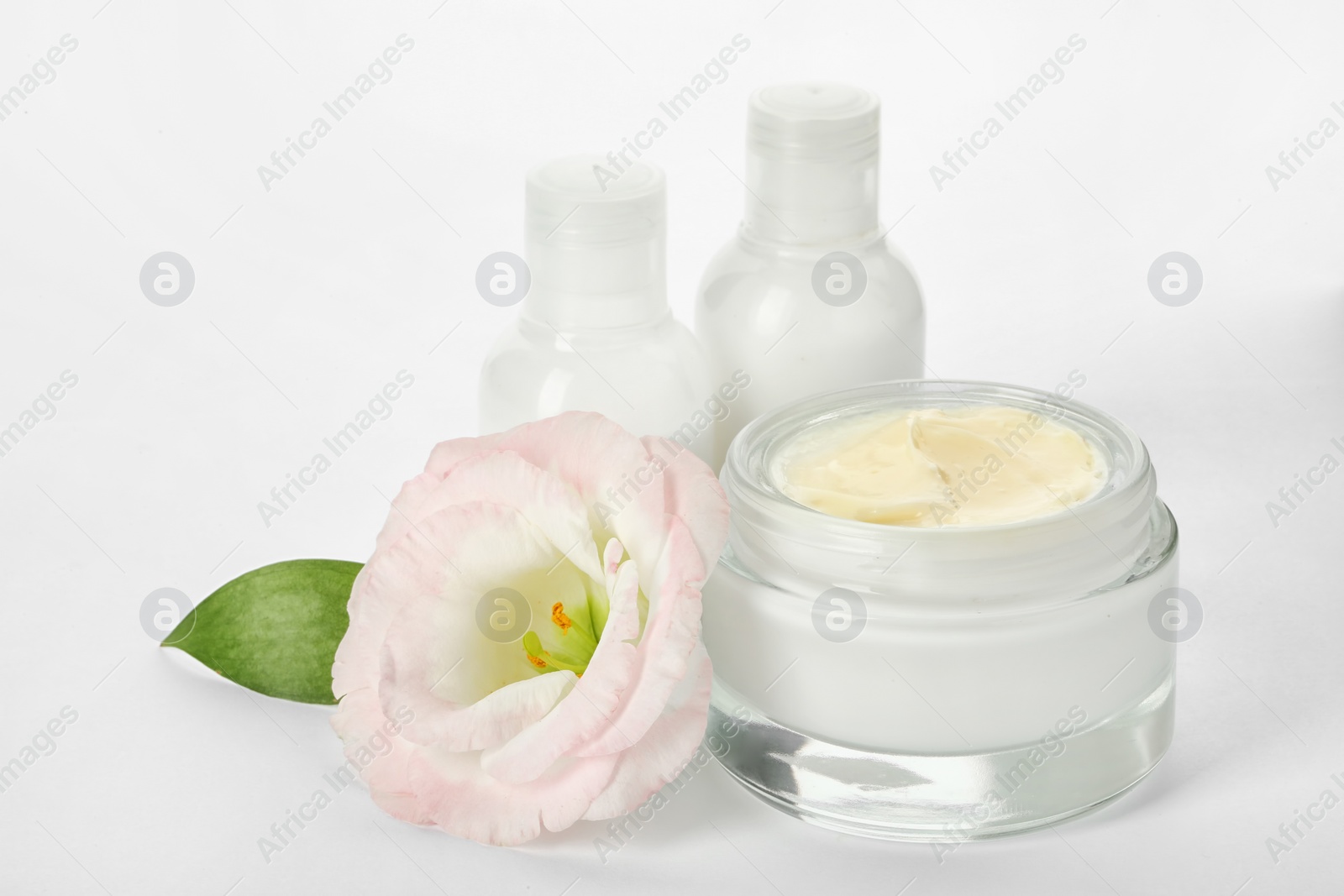 Photo of Jar with cream and bottles on white background. Hand care cosmetics