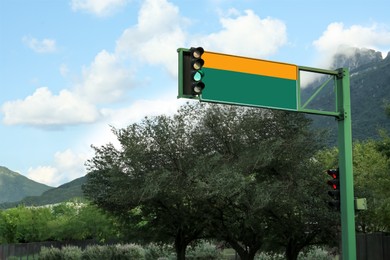 Photo of Traffic light and road sign outdoors on sunny day