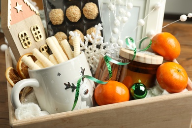 Photo of Christmas gift set in wooden crate, closeup