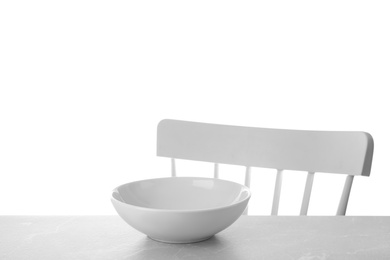 Empty bowl on light table against white background