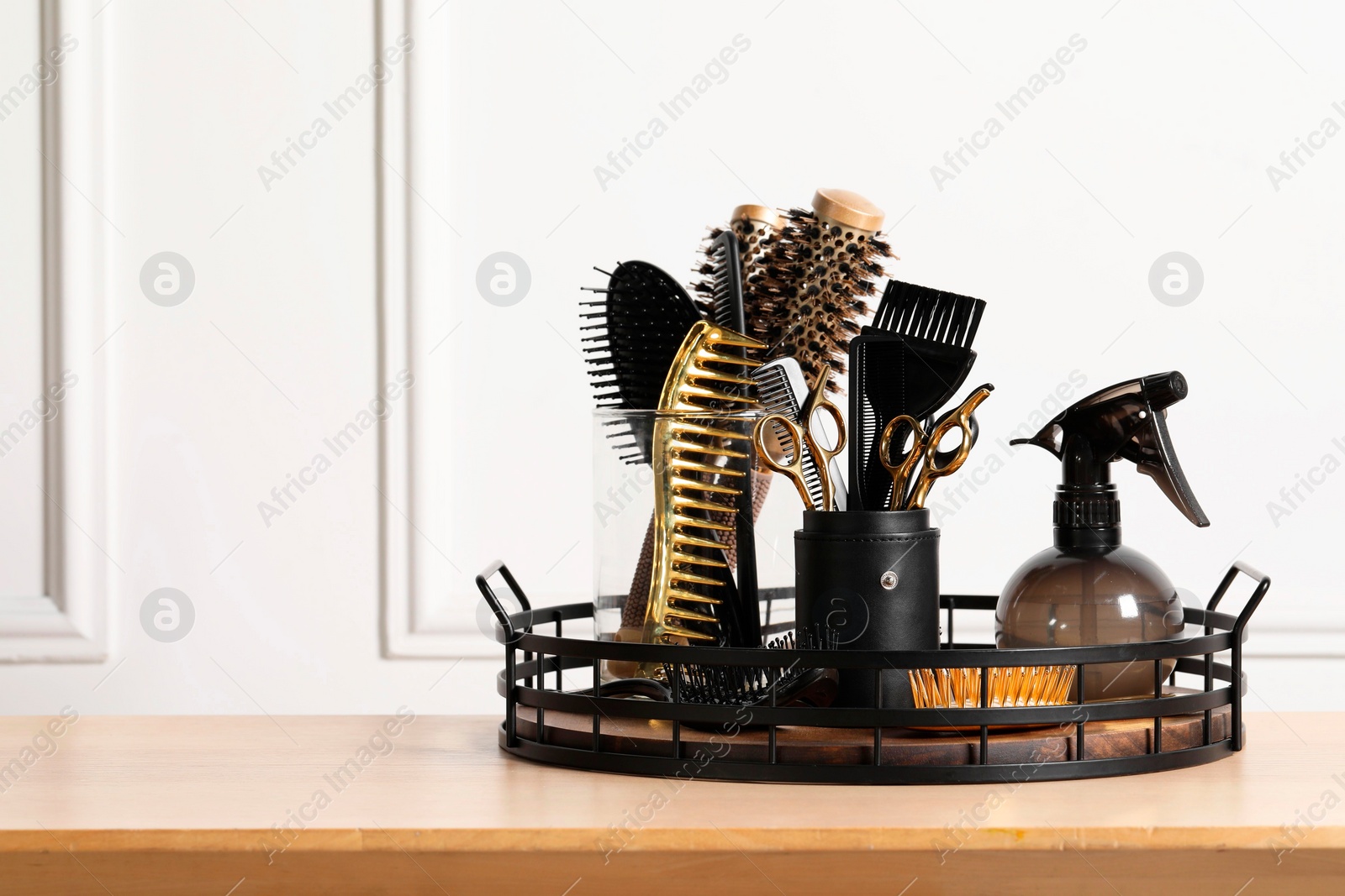 Photo of Set of hairdresser tools on table in salon, space for text