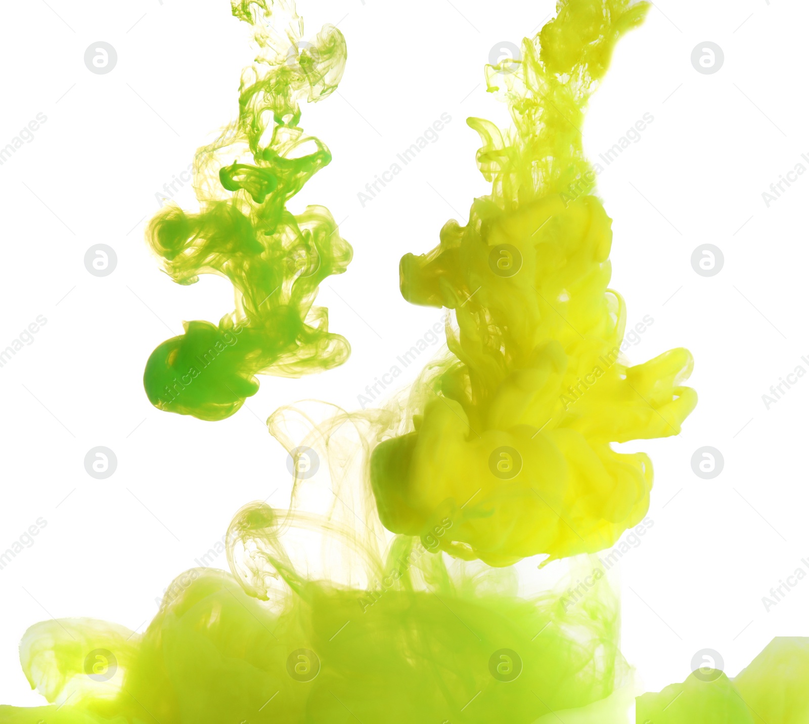 Photo of Splashes of yellow and green inks on light background, closeup