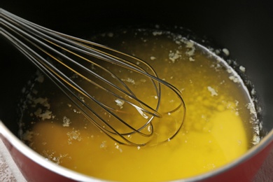 Photo of Whisk in pot of melting butter, closeup