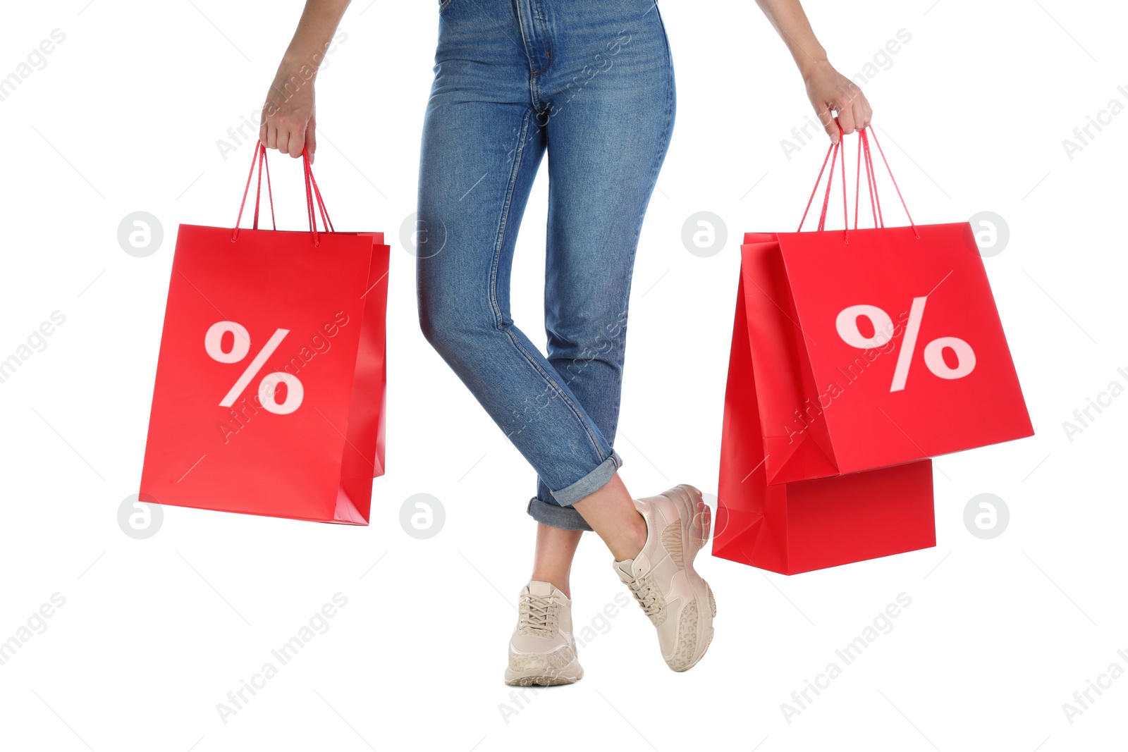 Image of Discount, sale, offer. Woman holding paper bags with percent signs against white background, closeup