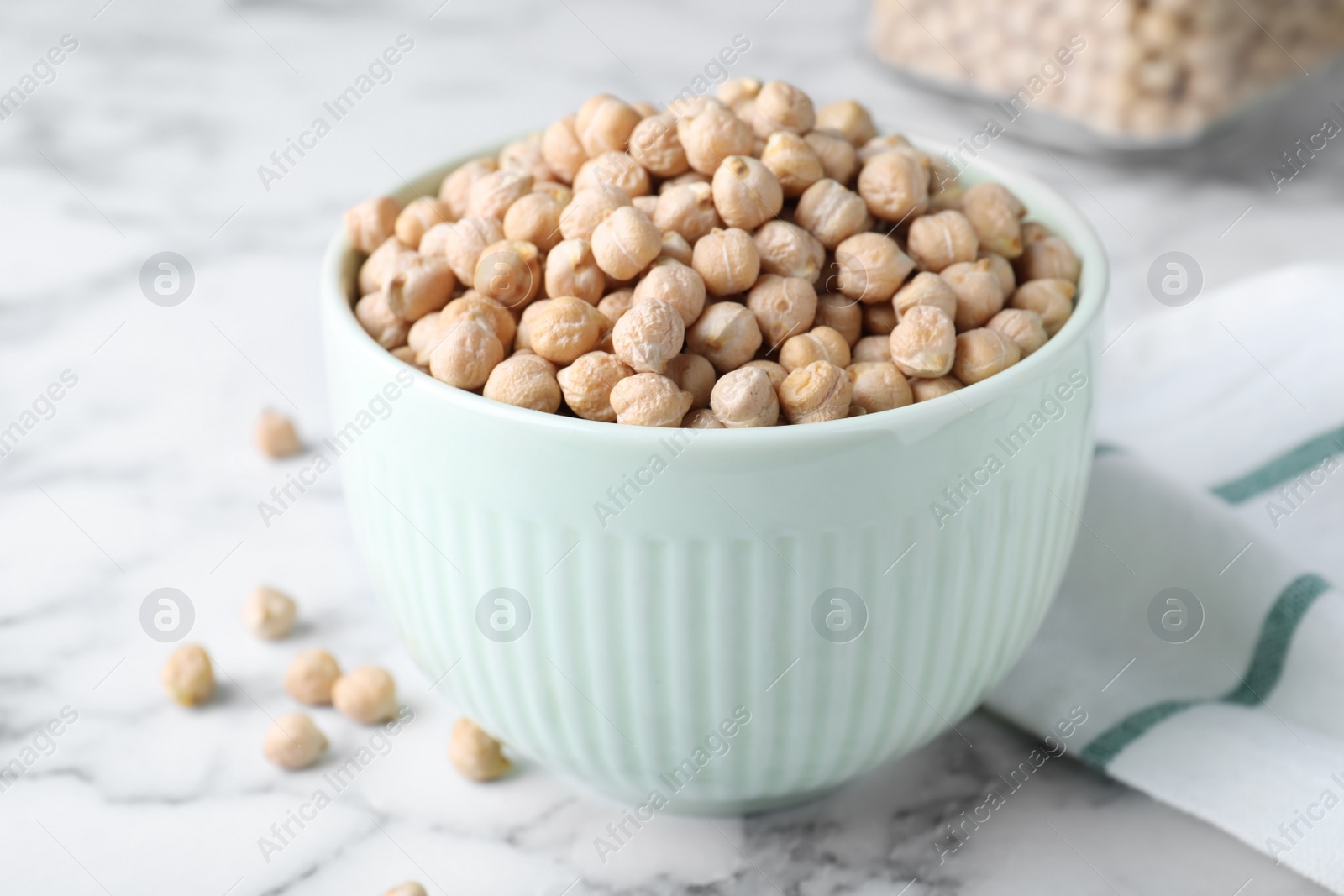 Photo of Chickpeas in bowl on white marble table