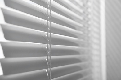 Photo of Closeup view of window with closed horizontal blinds