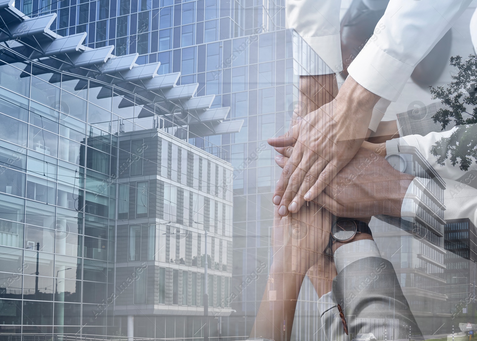 Image of Partnership concept. Double exposure of people joining hands together and cityscape