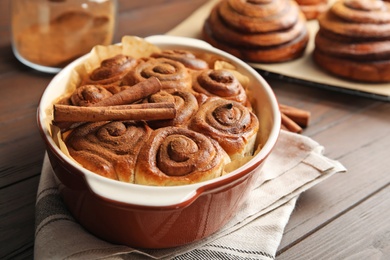 Photo of Baking dish with cinnamon rolls on table