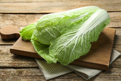 Photo of Fresh ripe Chinese cabbage on wooden table