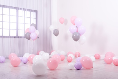 Photo of Room decorated with colorful balloons near wall