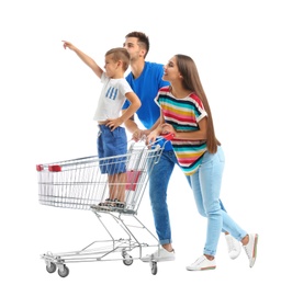Photo of Happy family with shopping cart on white background