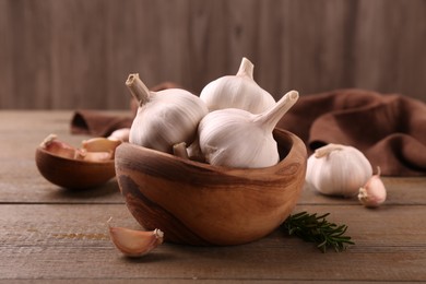 Photo of Fresh garlic on wooden table, closeup view