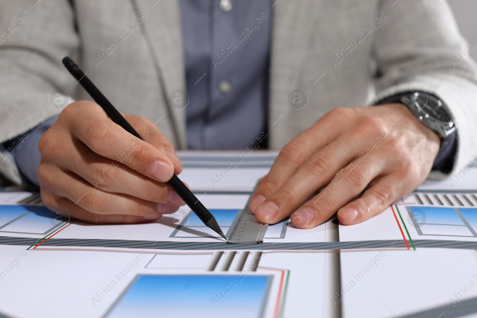 Photo of Architect working with construction drawings, closeup view