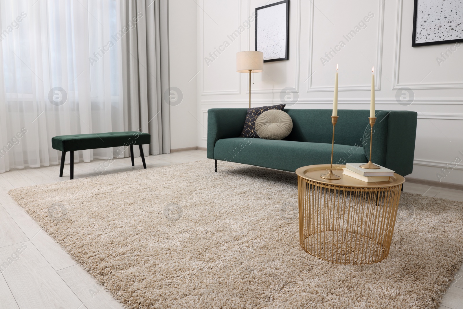 Photo of Stylish living room with soft beige carpet, coffee table and sofa. Interior design