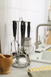 Photo of Countertop with sink and cooking utensils in kitchen