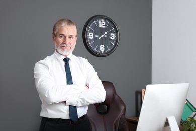 Photo of Serious senior successful boss in his office