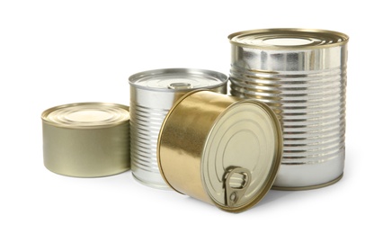 Photo of Closed tin cans isolated on white, mockup for design