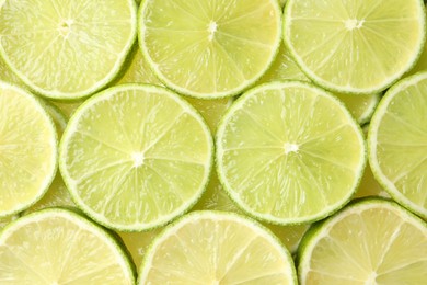 Photo of Fresh juicy lime slices as background, top view