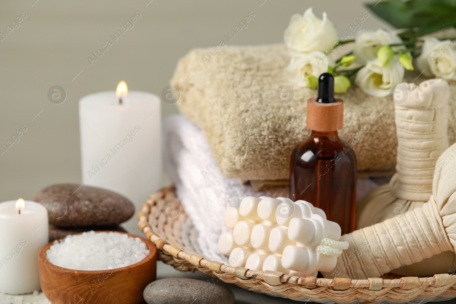 Photo of Beautiful composition with burning candles and different spa products on table, closeup