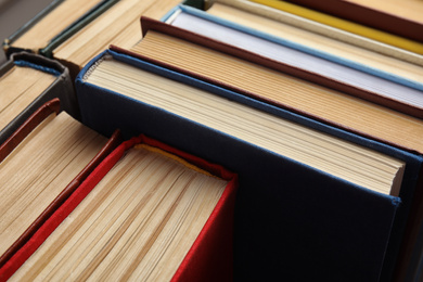 Photo of Many different hardcover books as background, closeup