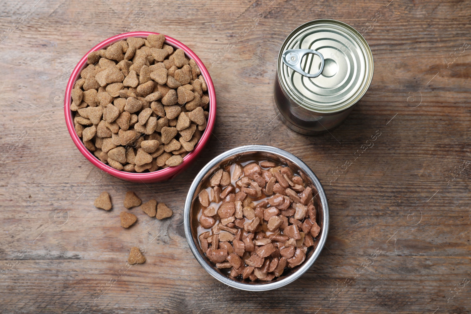 Photo of Wet and dry pet food on wooden table, flat lay