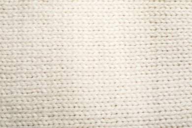 Texture of cozy warm sweater as background, closeup