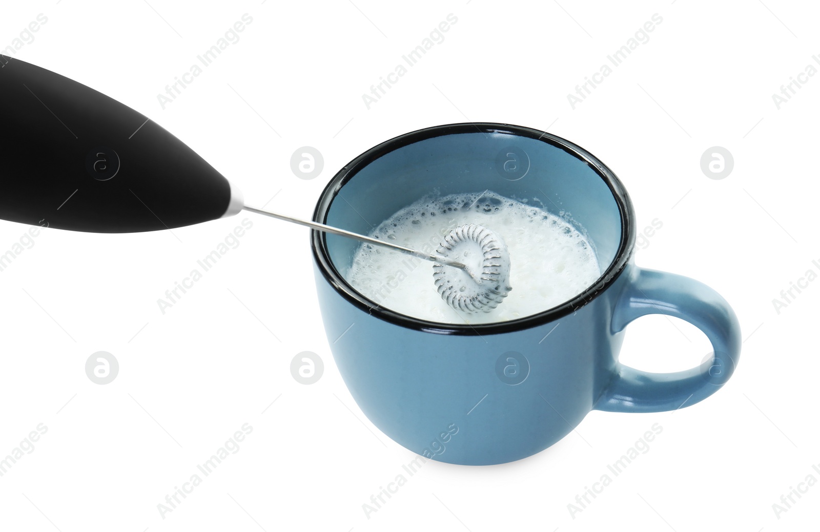 Photo of Whisking milk in cup with mini mixer (frother wand) isolated on white, closeup