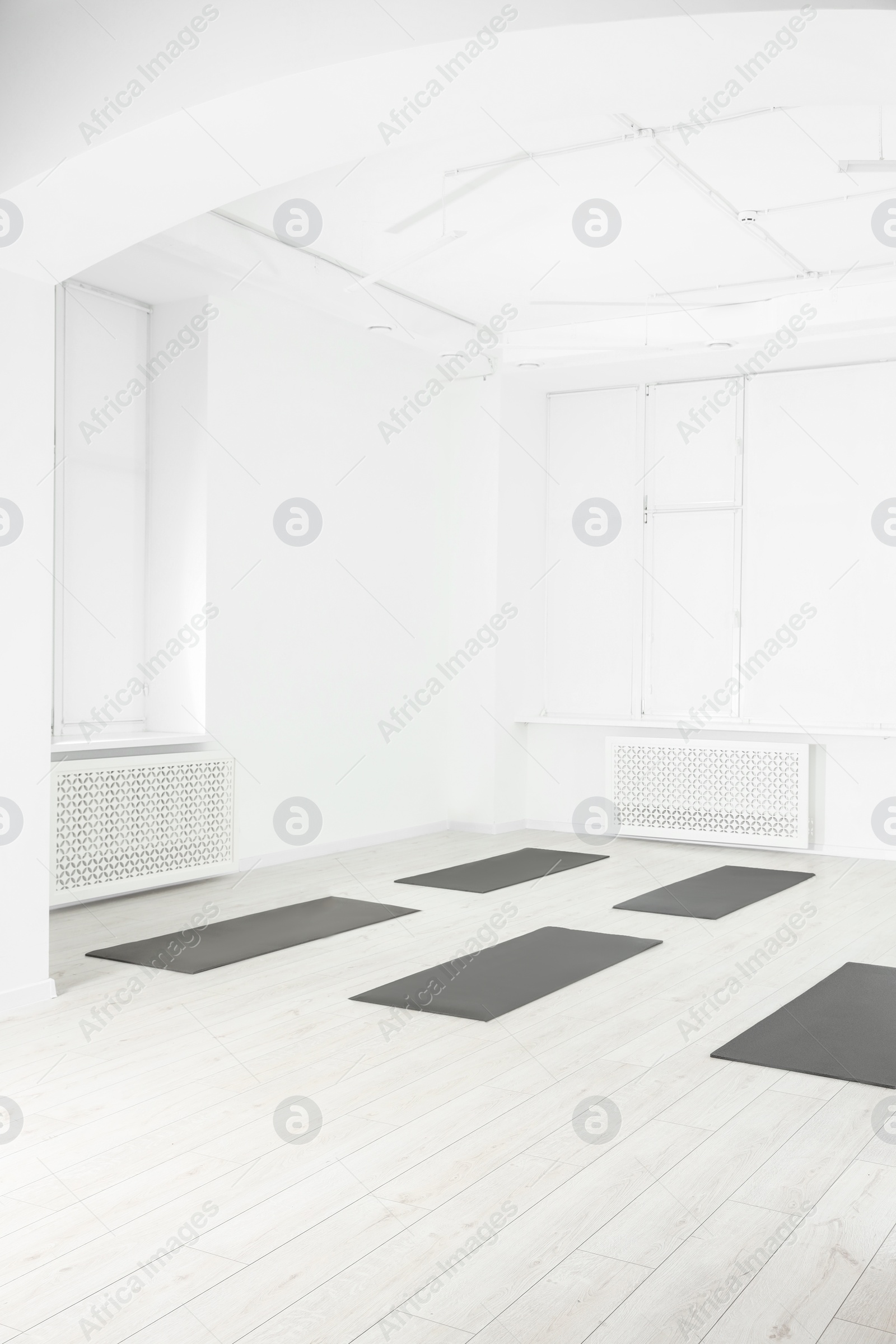 Photo of Spacious yoga studio with exercise mats on floor