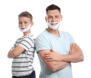 Photo of Happy dad and son with shaving foam on faces, white background