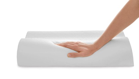Woman touching orthopedic memory foam pillow on white background, closeup